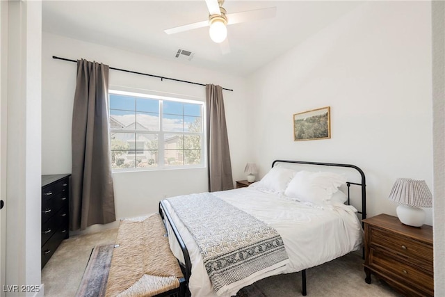 bedroom with a ceiling fan, visible vents, and light carpet