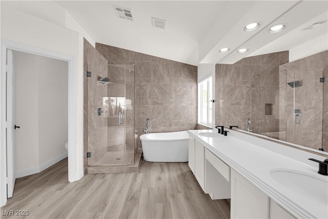 full bathroom with recessed lighting, visible vents, a sink, and a stall shower