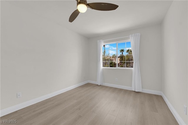 unfurnished room with baseboards, ceiling fan, and light wood-type flooring