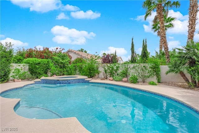 view of pool featuring a fenced backyard and a pool with connected hot tub