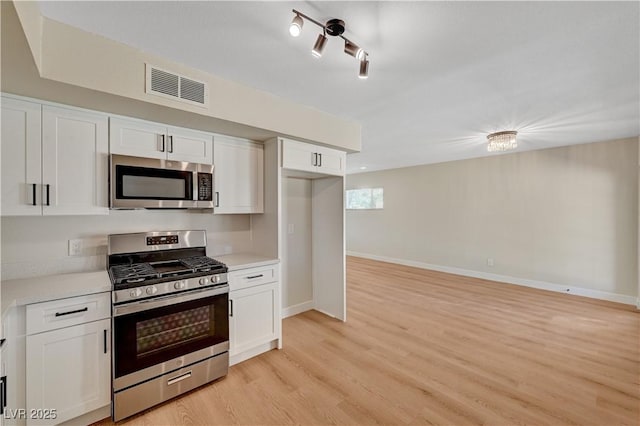 4804 Apawana Ln, Las Vegas, NV 89108 - kitchen featuring appliances with stainless steel finishes, light countertops, and white cabinets