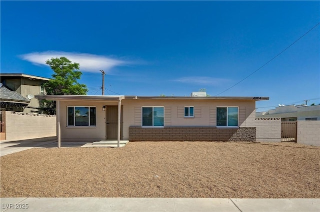single story home featuring fence