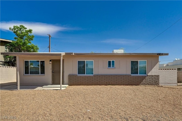 rear view of property featuring fence