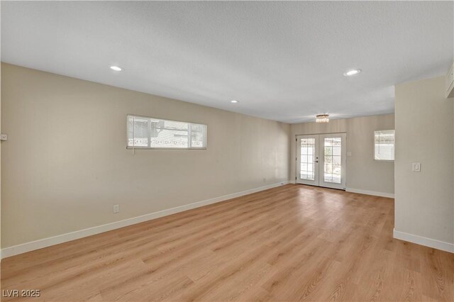 unfurnished room featuring baseboards, light wood-style flooring, and recessed lighting