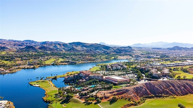 aerial view with view of golf course and a water and mountain view