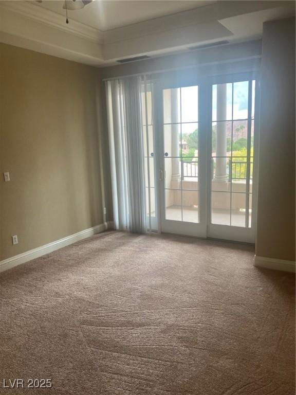32 Via Vasari Unit 103, Henderson, NV 89011 - empty room featuring a tray ceiling, baseboards, ceiling fan, and carpet floors