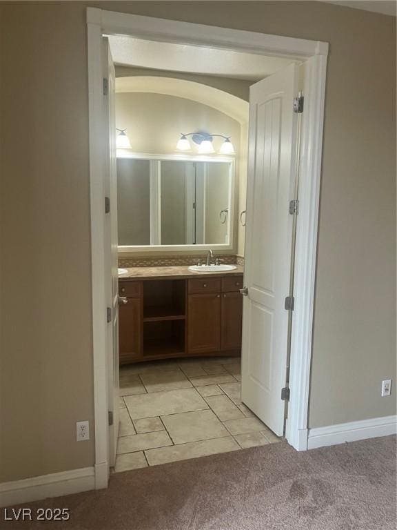 32 Via Vasari Unit 103, Henderson, NV 89011 - bathroom featuring tile patterned floors, baseboards, and vanity