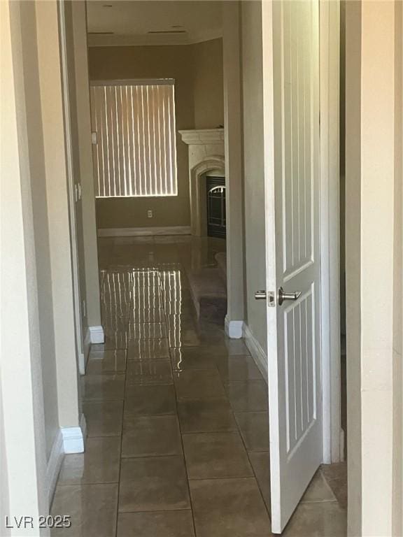 32 Via Vasari Unit 103, Henderson, NV 89011 - corridor with baseboards and tile patterned floors