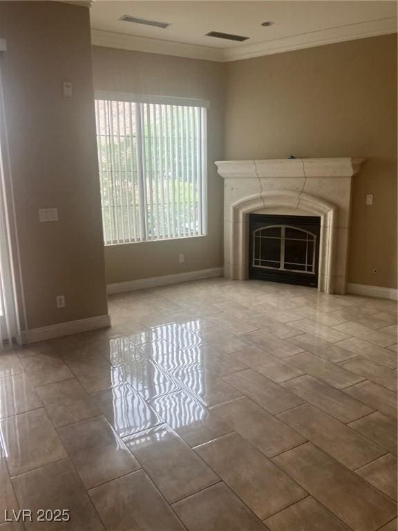 32 Via Vasari Unit 103, Henderson, NV 89011 - unfurnished living room featuring ornamental molding, baseboards, a glass covered fireplace, and visible vents