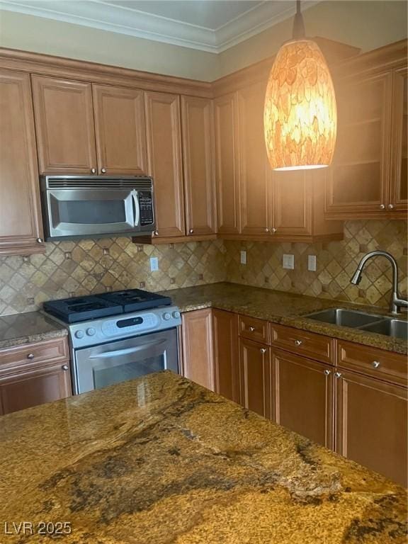 32 Via Vasari Unit 103, Henderson, NV 89011 - kitchen with dark stone countertops, appliances with stainless steel finishes, and a sink