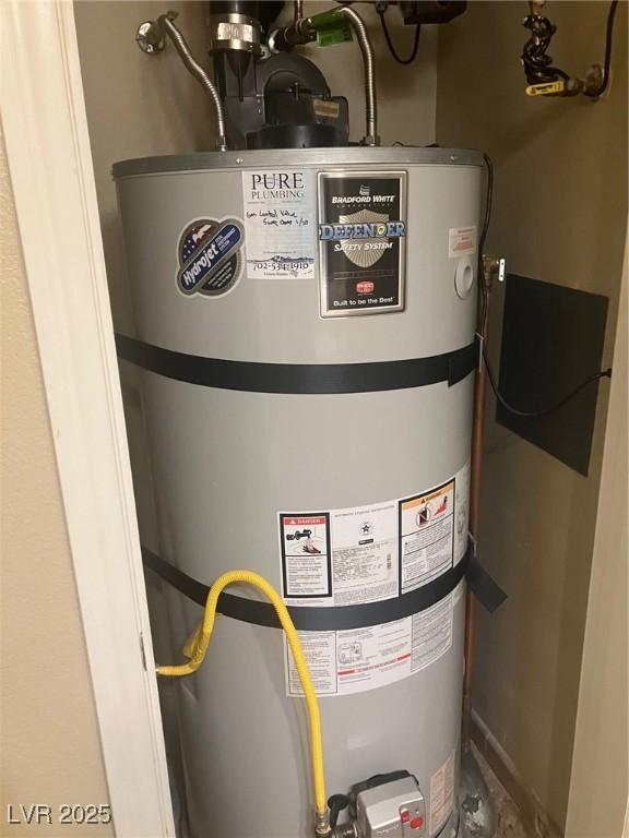 32 Via Vasari Unit 103, Henderson, NV 89011 - utility room with strapped water heater