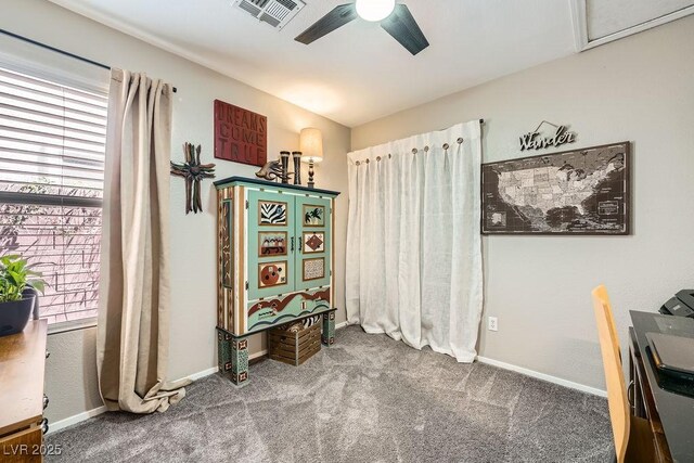 carpeted office featuring visible vents, a ceiling fan, and baseboards