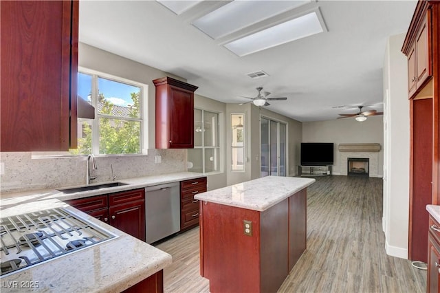 kitchen with visible vents, a sink, dark brown cabinets, and stainless steel appliances