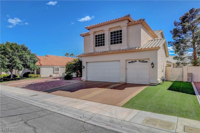 mediterranean / spanish-style home with a garage, stucco siding, a gate, a tiled roof, and concrete driveway