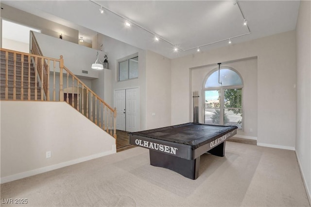 game room featuring baseboards, rail lighting, and carpet floors