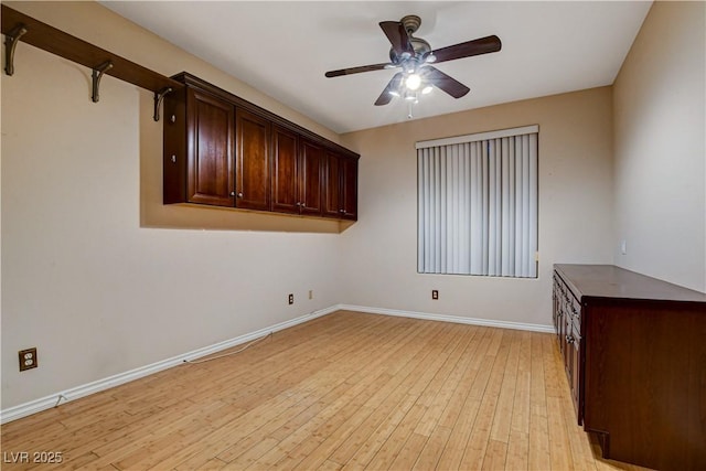 unfurnished room featuring baseboards, ceiling fan, and light wood-type flooring