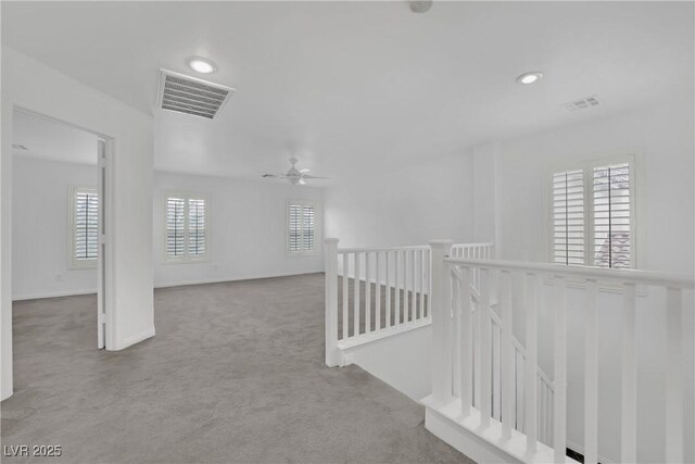 interior space with visible vents, carpet flooring, ceiling fan, and recessed lighting