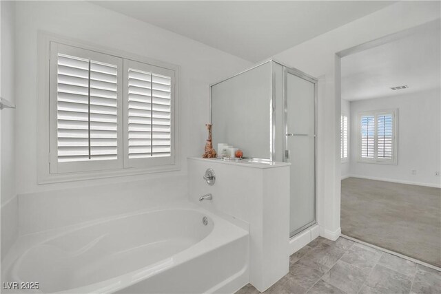full bath featuring baseboards, visible vents, a shower stall, and a garden tub