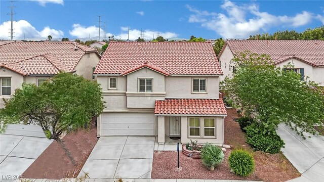 mediterranean / spanish-style house with a residential view, an attached garage, stucco siding, concrete driveway, and a tiled roof