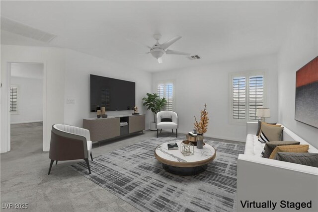 living room with carpet flooring, ceiling fan, visible vents, and baseboards