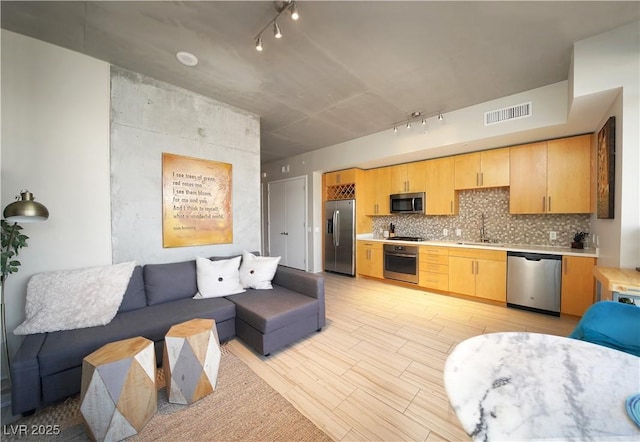353 E Bonneville Ave Unit 215, Las Vegas, NV 89101 - living room with rail lighting, visible vents, and light wood-style floors