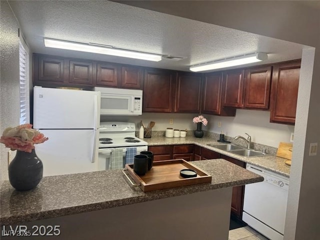 4965 Indian River Dr Unit 101, Las Vegas, NV 89103 - kitchen featuring white appliances, a textured ceiling, dark countertops, and a sink