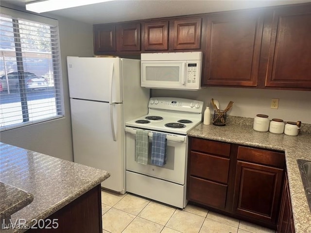 4965 Indian River Dr Unit 101, Las Vegas, NV 89103 - kitchen with plenty of natural light, white appliances, and light tile patterned flooring