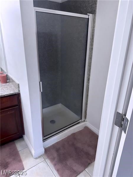 4965 Indian River Dr Unit 101, Las Vegas, NV 89103 - bathroom with tile patterned floors, a shower stall, and baseboards