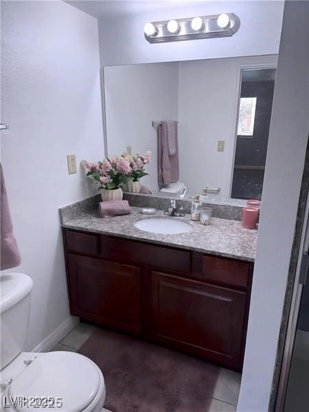 4965 Indian River Dr Unit 101, Las Vegas, NV 89103 - bathroom with toilet, tile patterned flooring, and vanity