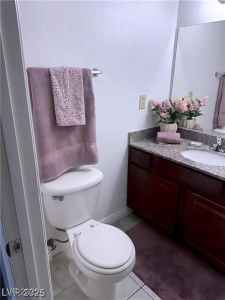 4965 Indian River Dr Unit 101, Las Vegas, NV 89103 - bathroom with vanity, tile patterned flooring, baseboards, and toilet