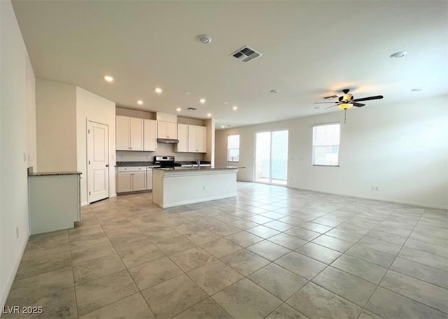 2970 Saltillo Ln, Las Vegas, NV 89121 - kitchen with dark countertops, visible vents, stainless steel electric range, and open floor plan