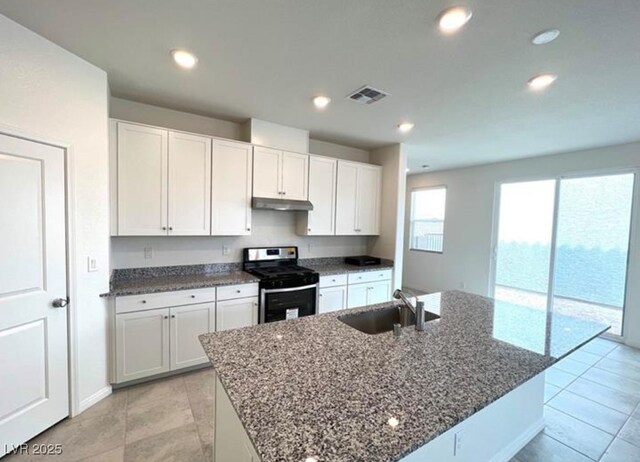 2970 Saltillo Ln, Las Vegas, NV 89121 - kitchen featuring visible vents, stainless steel gas range oven, a sink, dark stone counters, and under cabinet range hood