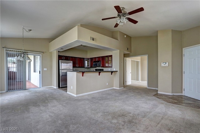1608 Sussex St Unit 204, Las Vegas, NV 89144 - unfurnished living room featuring light colored carpet, baseboards, visible vents, and ceiling fan with notable chandelier