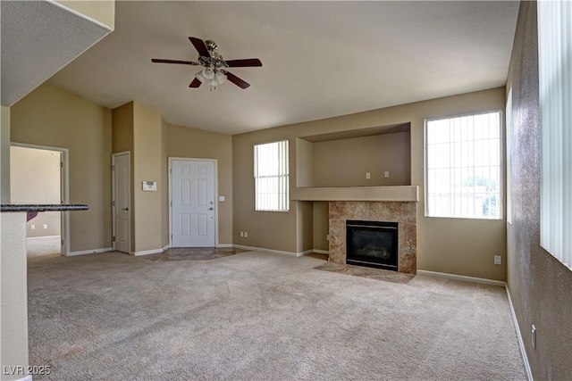 1608 Sussex St Unit 204, Las Vegas, NV 89144 - unfurnished living room featuring a ceiling fan, a fireplace, baseboards, carpet flooring, and vaulted ceiling