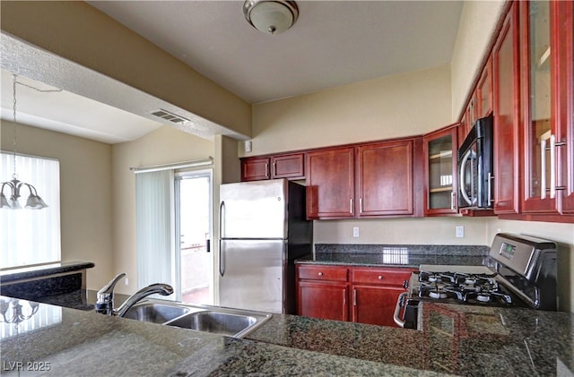 1608 Sussex St Unit 204, Las Vegas, NV 89144 - kitchen featuring a sink, appliances with stainless steel finishes, visible vents, and reddish brown cabinets