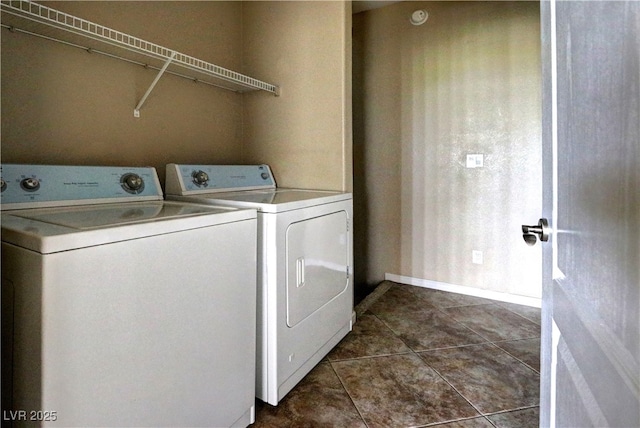 1608 Sussex St Unit 204, Las Vegas, NV 89144 - clothes washing area featuring dark tile patterned floors, baseboards, laundry area, and independent washer and dryer