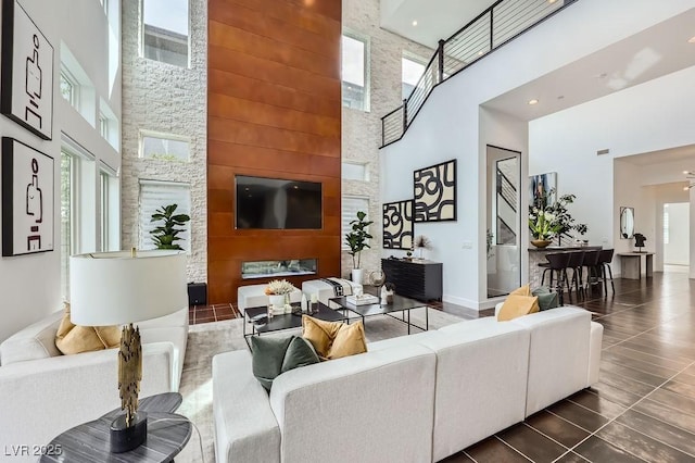 living room featuring dark tile patterned flooring and a high ceiling