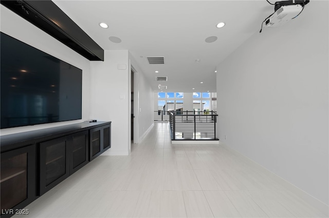 hall with visible vents, recessed lighting, baseboards, and light tile patterned floors