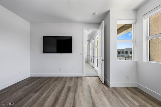 unfurnished bedroom featuring baseboards and wood finished floors