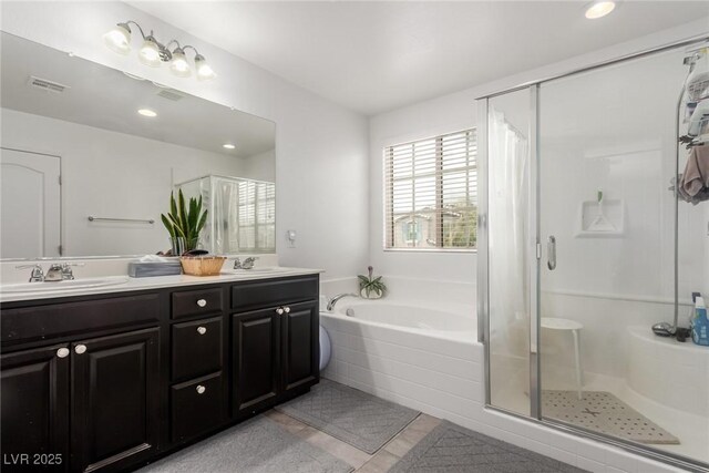 bathroom with a sink and a stall shower