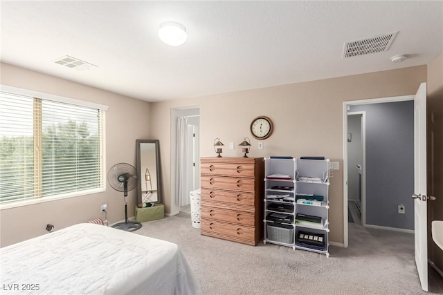 bedroom with baseboards, visible vents, and carpet