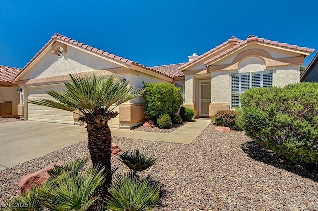 1574 Livingston Dr, Henderson, NV 89012 - view of front of home featuring stucco siding, an attached garage, driveway, and a tile roof