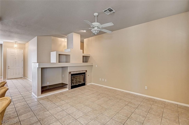 1574 Livingston Dr, Henderson, NV 89012 - unfurnished living room with light tile patterned flooring, a ceiling fan, and a tiled fireplace