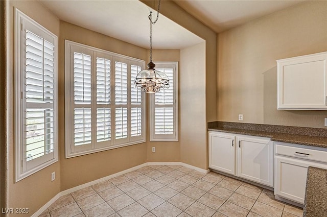 1574 Livingston Dr, Henderson, NV 89012 - unfurnished dining area with healthy amount of natural light, a chandelier, and light tile patterned flooring