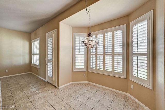 1574 Livingston Dr, Henderson, NV 89012 - unfurnished dining area with a chandelier, light tile patterned floors, and plenty of natural light