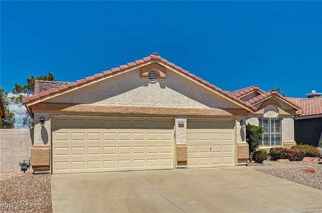 1574 Livingston Dr, Henderson, NV 89012 - mediterranean / spanish home with a garage, driveway, stucco siding, and a tile roof