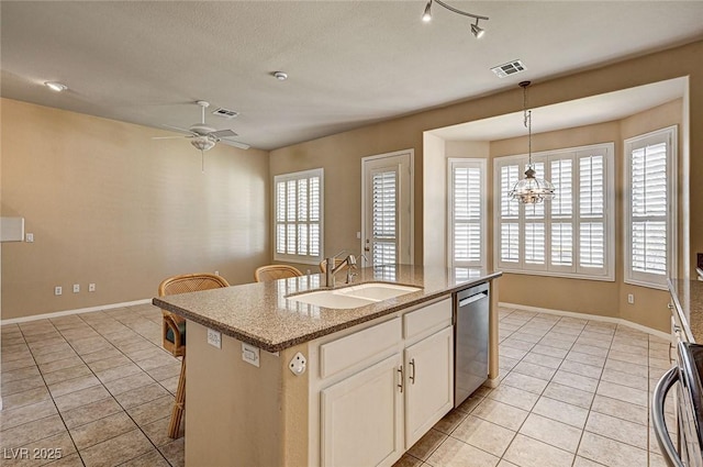 1574 Livingston Dr, Henderson, NV 89012 - kitchen with dishwasher, light tile patterned floors, and healthy amount of natural light