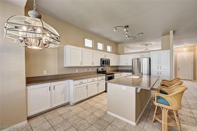1574 Livingston Dr, Henderson, NV 89012 - kitchen featuring stainless steel appliances, light tile patterned floors, white cabinets, and stone counters