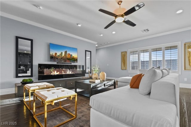 cinema room with a ceiling fan, visible vents, crown molding, baseboards, and recessed lighting