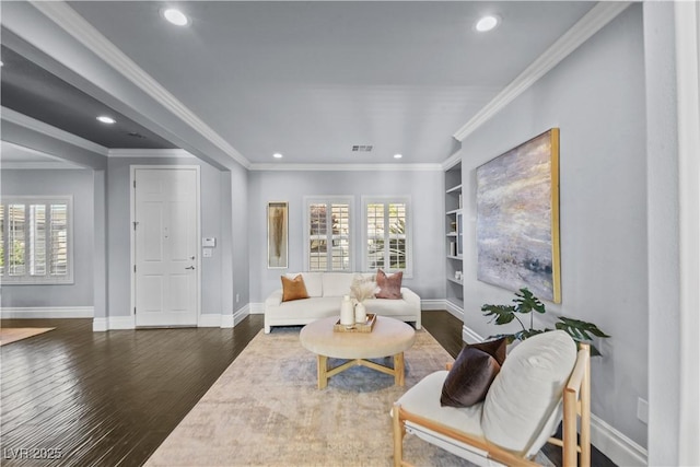 living area with recessed lighting, a healthy amount of sunlight, and wood finished floors